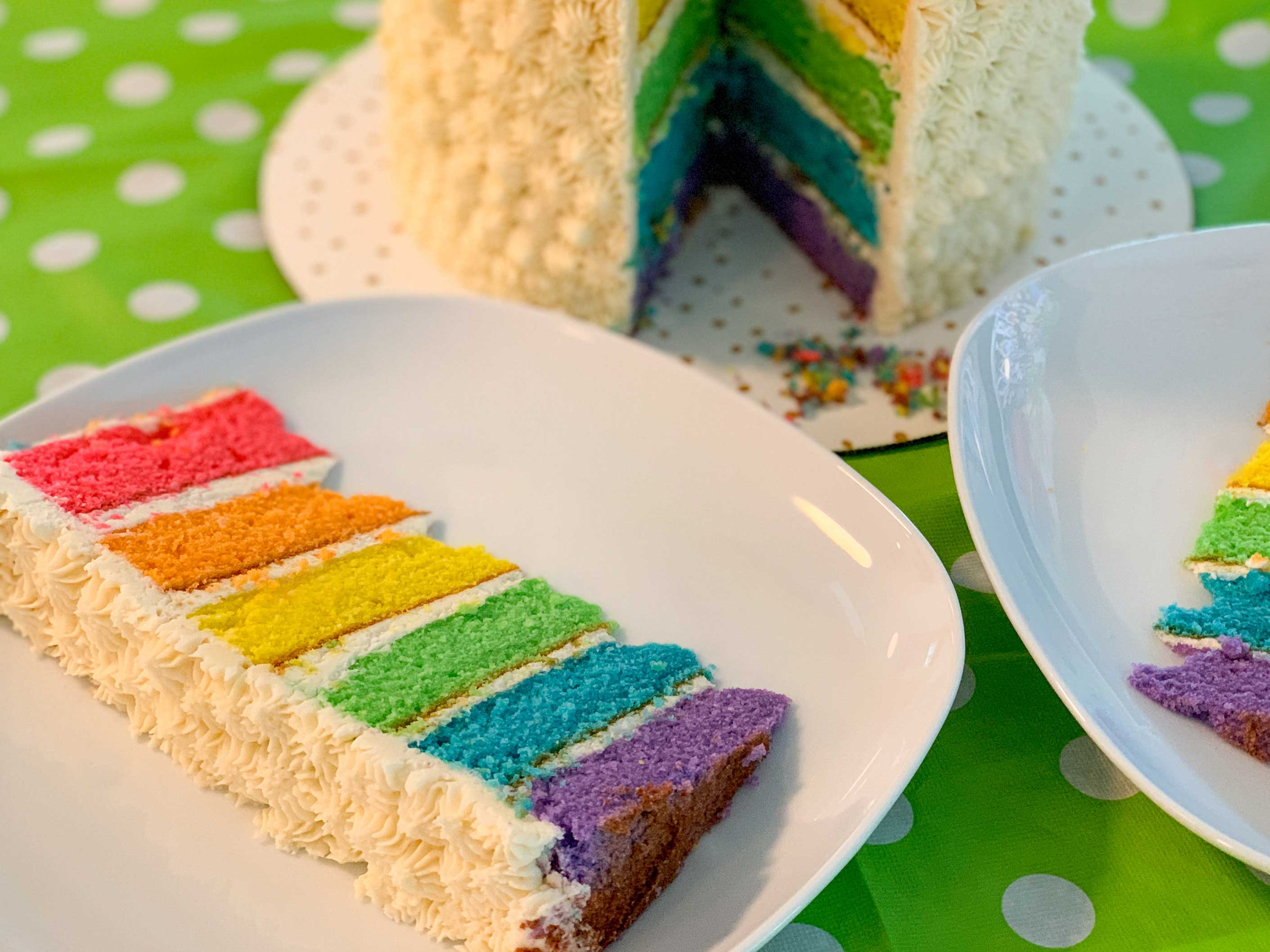 close up shot of a slice of the rainbow cake