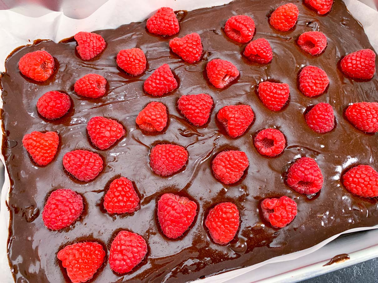 Raspberries on top of brownie butter, ready for the oven