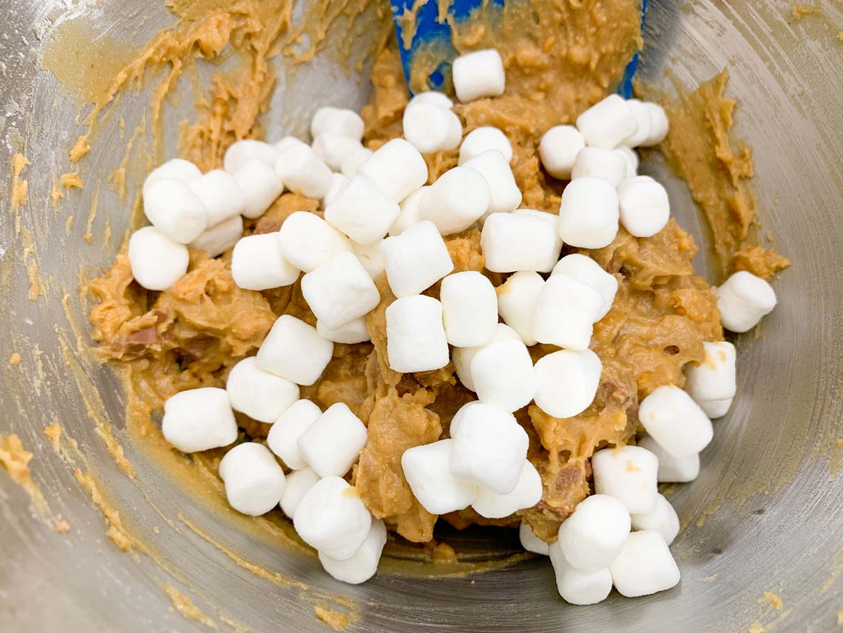 adding the marshmallows to the s'mores cookie dough