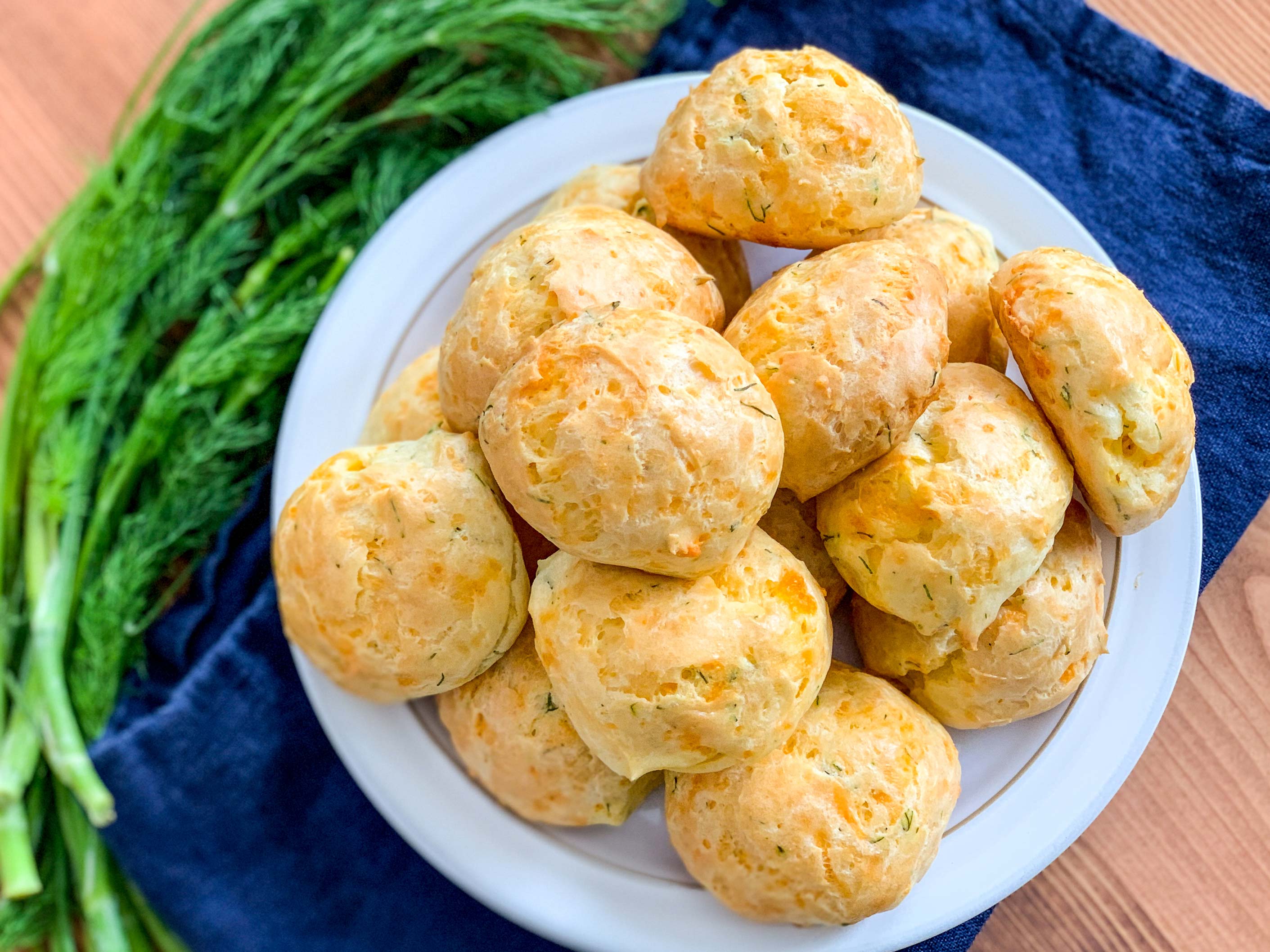 cheddar cheese and dill puffs on a plate