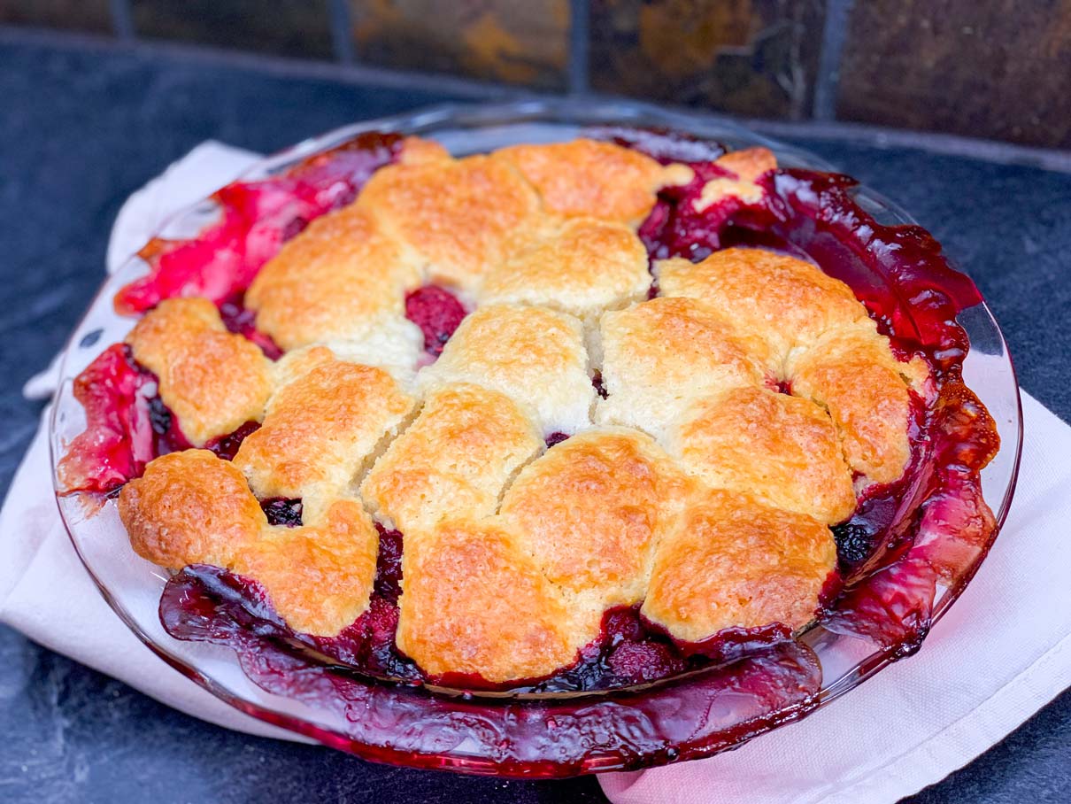 mixed berry cobbler, fresh from the oven, cooling on the counter