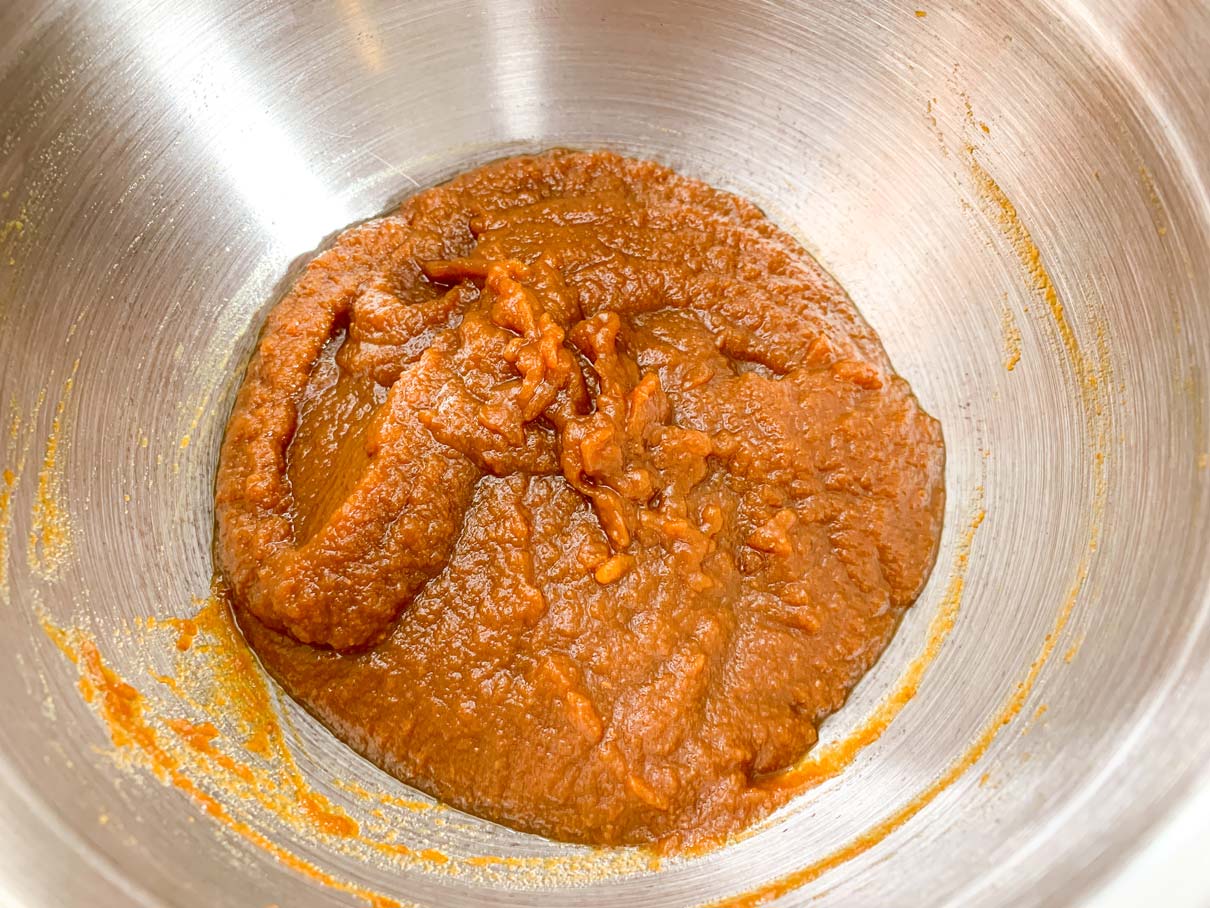 pumpkin and brown sugar stirred together in a mixing bowl