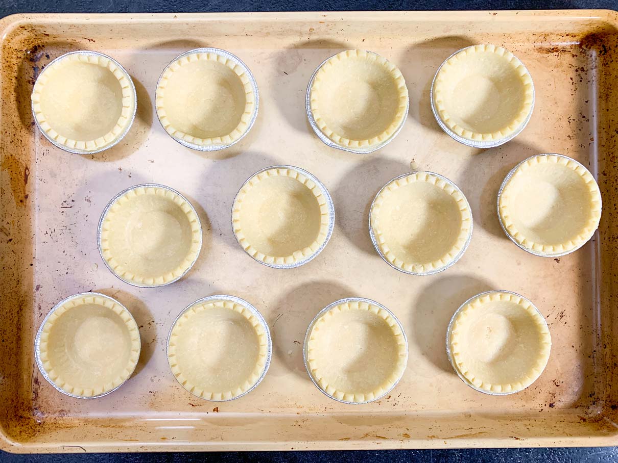 tray of empty tart shells, ready to be filled