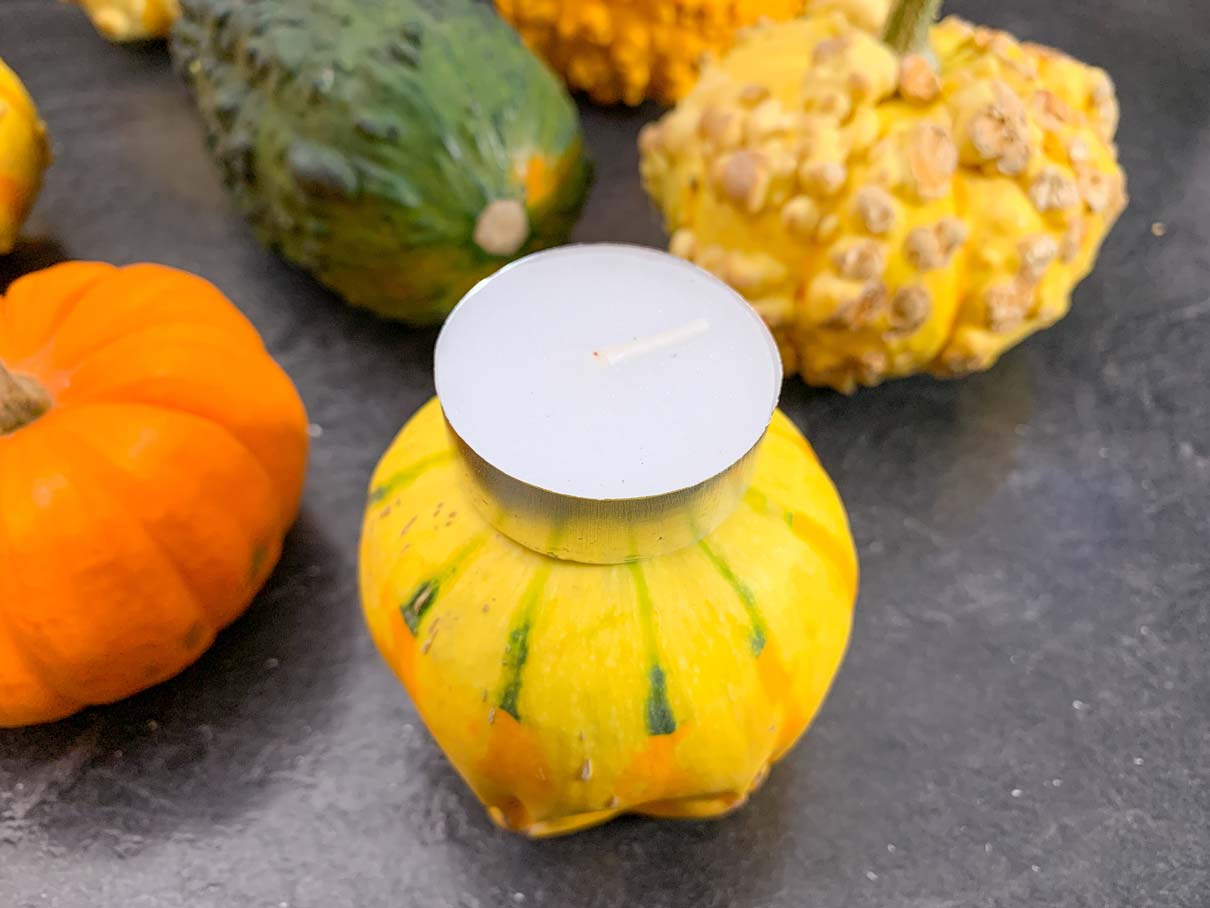 placing a tea light on top of a gourd to measure the size