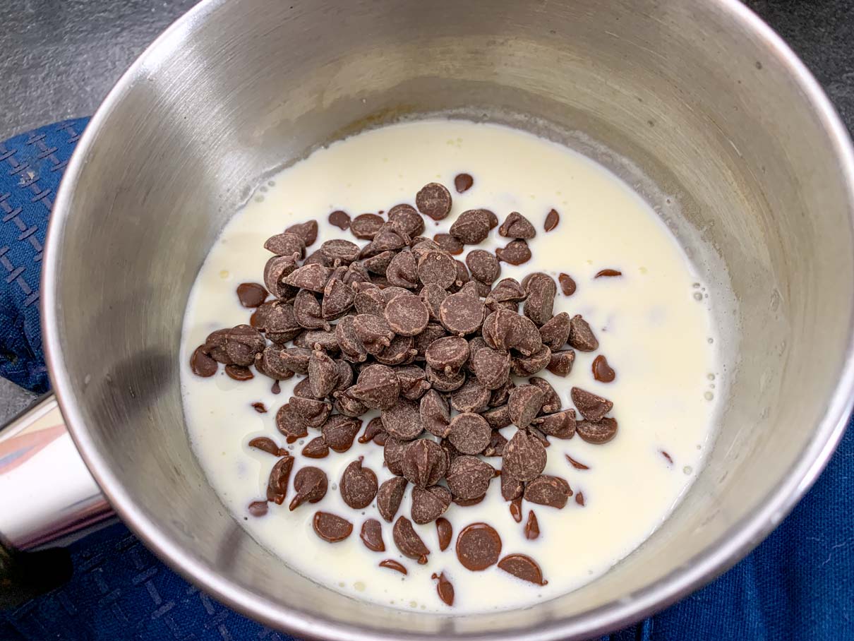 Cream and chocolate in a saucepan for the ganache layer