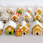 a group of mini gingerbread houses after they have been decorated