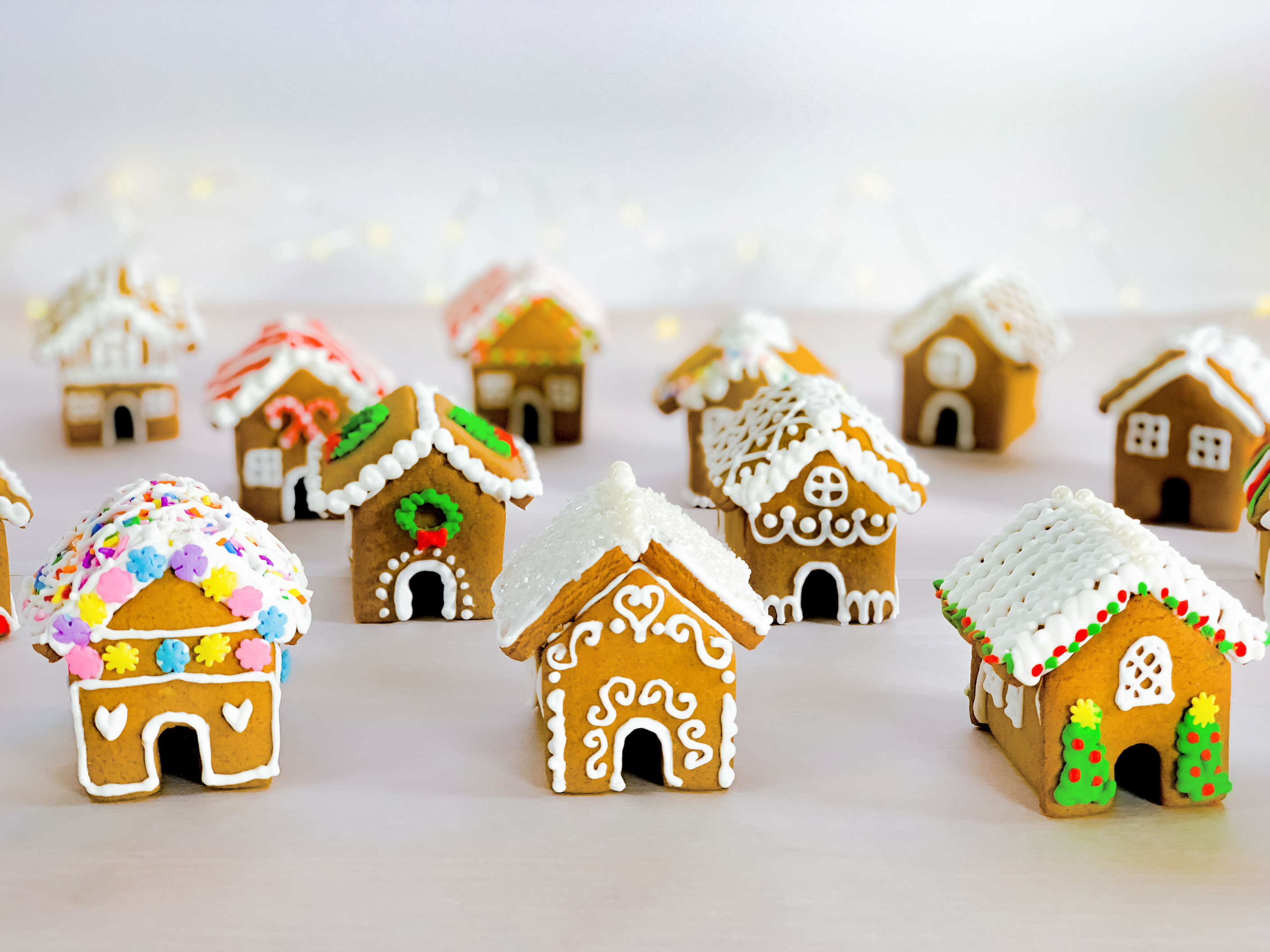 a group of mini gingerbread houses after they have been decorated