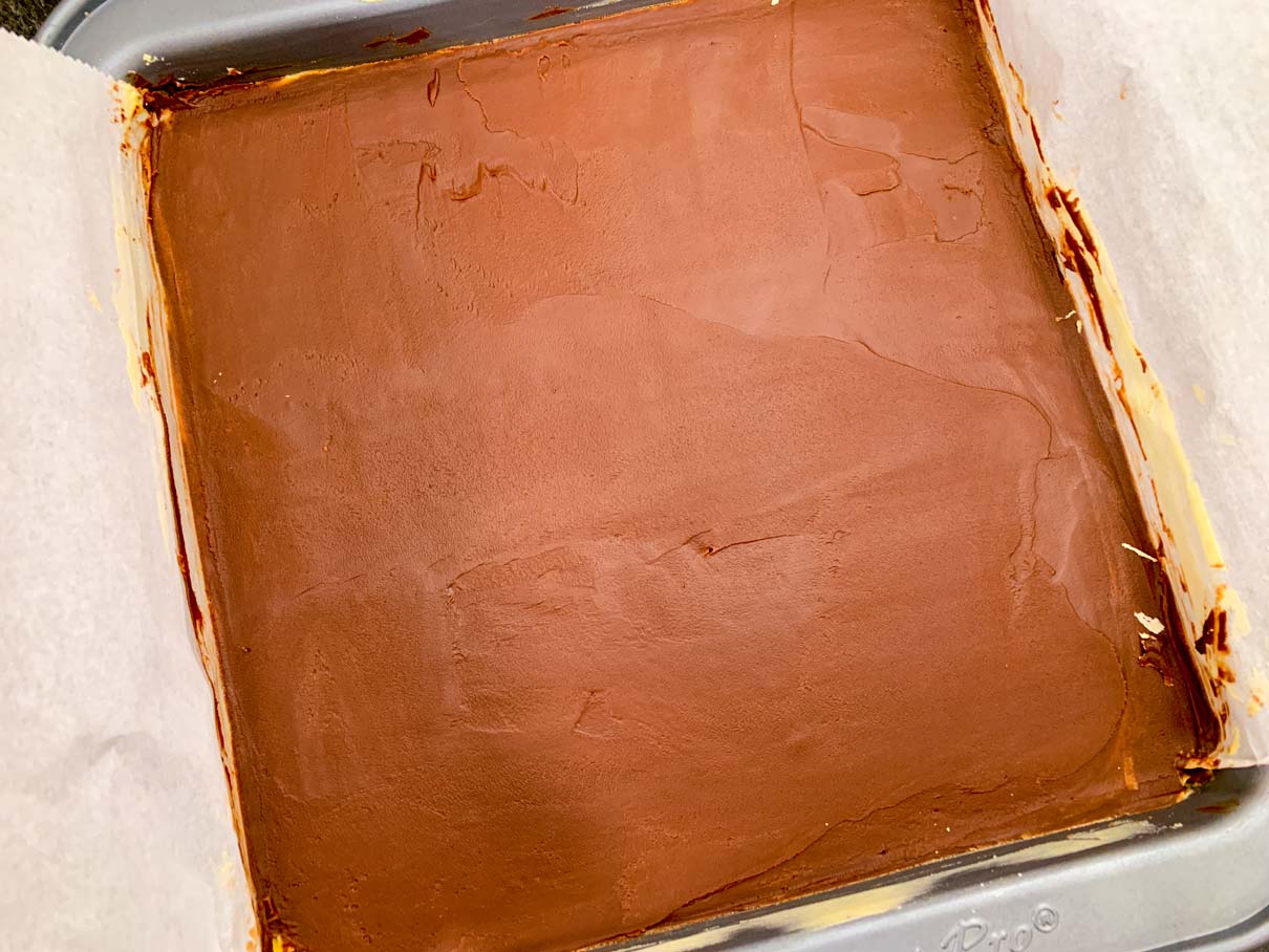 The pan of Nanaimo bars, after the chocolate has been smoothed onto the surface