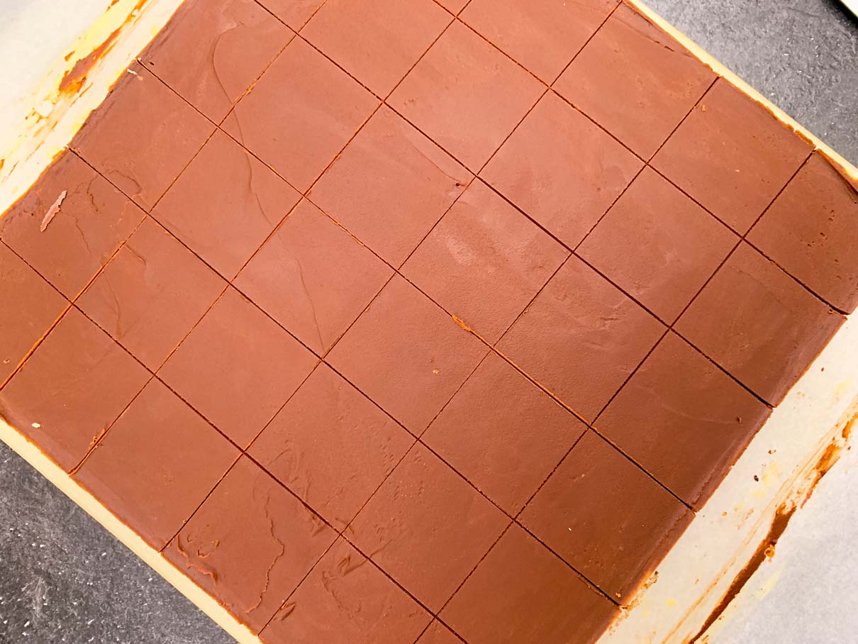 The top of the Nanaimo bars, after the chocolate has been scored with a knife, ready to cut into small squares