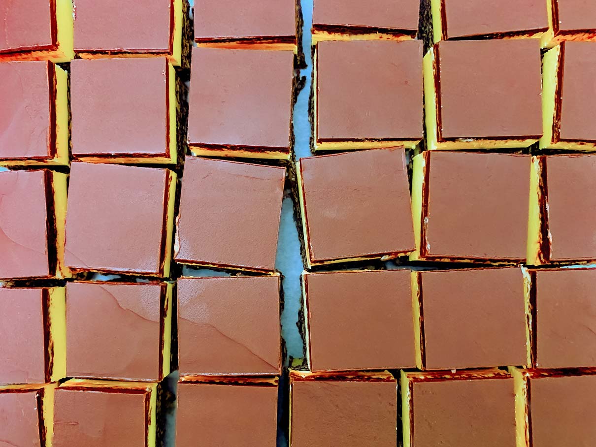 Birds eye view of the Nanaimo bars after they have all been cut into squares