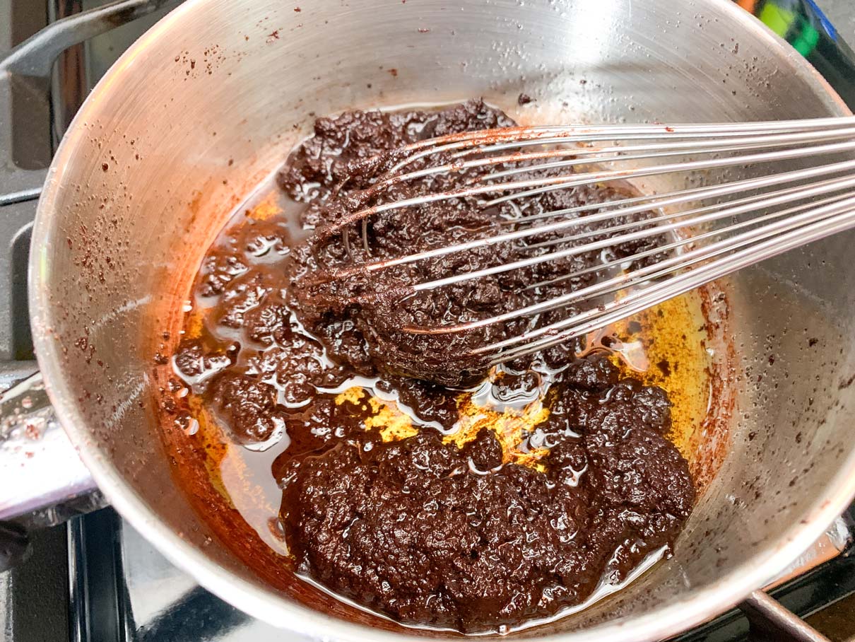 The butter/cocoa/sugar mixture after adding an egg. It has gone thick and slightly curdled looking, which it probably shouldn't have