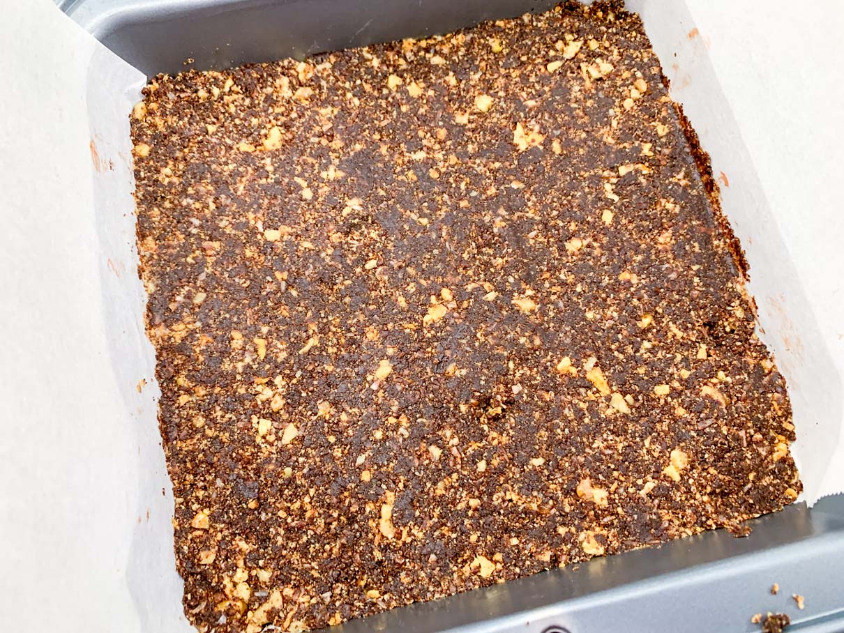 The bottom layer of the bars, pressed down flat into the pan