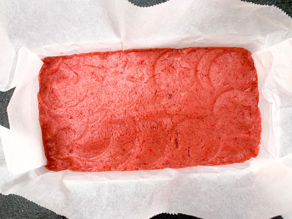 layer of strawberry dough pressed into the container