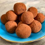 a small plate of vegan chocolate avocado truffles