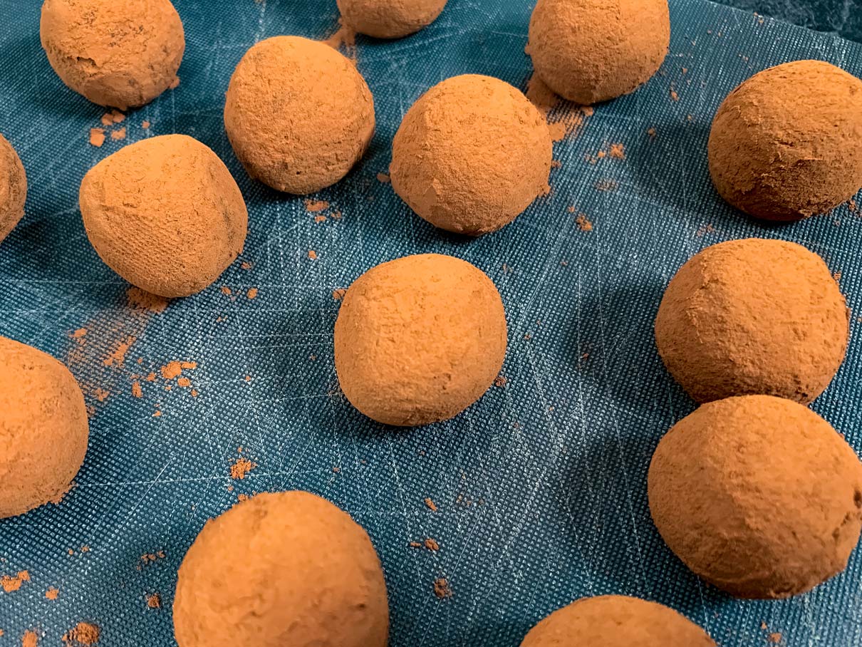 all the chocolate truffle balls on a cutting board