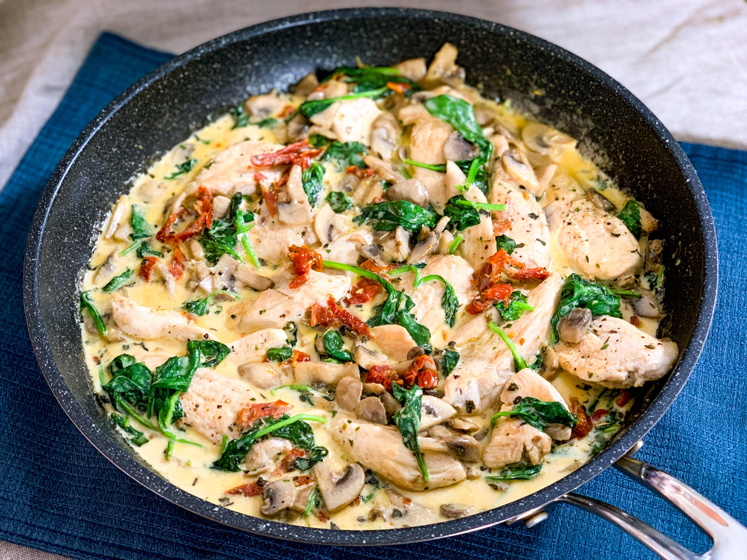 close up of creamy tuscan garlic chicken in frying pan