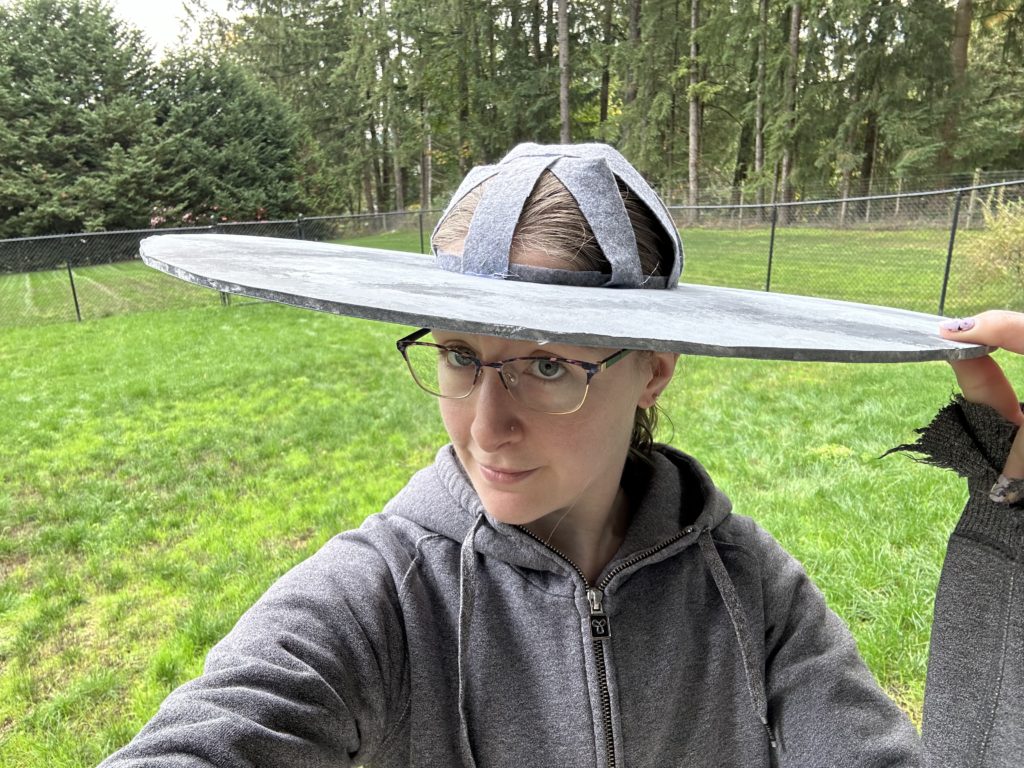 Selfie of my wearing the cloud hat after attaching the felt strips.