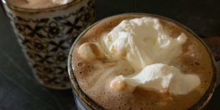 hot chocolate in mugs, topped with whipped cream