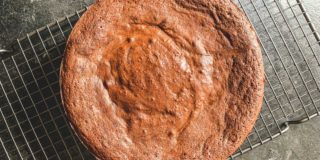 overhead shot of flourless chocolate cake on a cooling rack