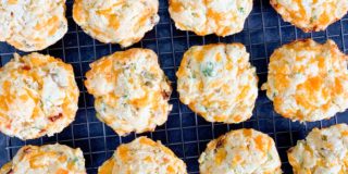 overhead shot of cheese muffins cooling on a wire rack